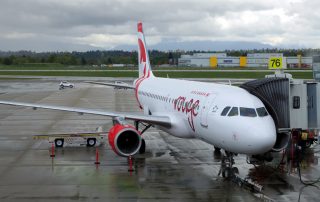 Air Canada rouge's inaugural YVR-LAS Airbus A319 flight at the gate on a rainy Vancouver morning