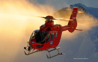 An H135 belonging to Heli-Austria flies in front of a peak in the Austrian Alps. Photo: Anthony Pecchi